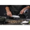 Chef,Cook,Holds,A,Knife,Over,Dark,Grey,Background.